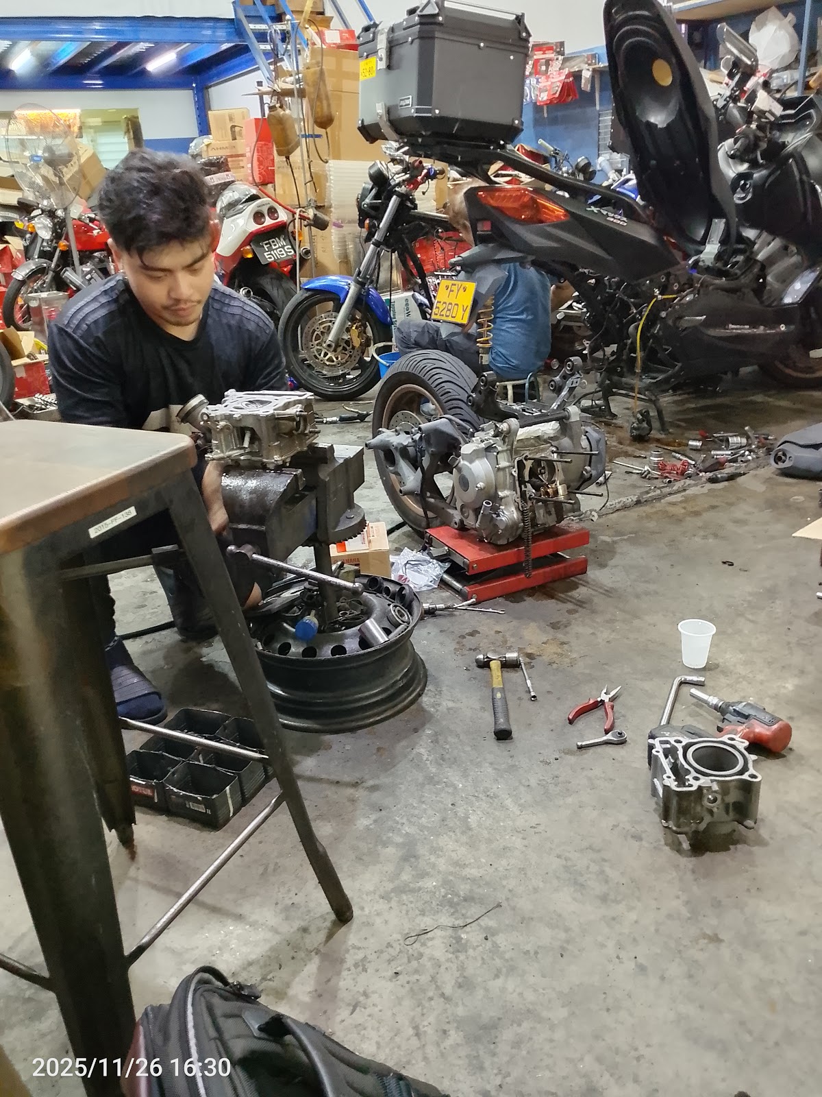 Inside the R'S BIKES workshop at Kaki Bukit — the team mid-overhaul on a Yamaha CVT scooter